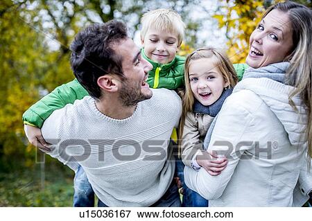 Family enjoying in autumn View Large Photo Image Stock Photo - Family enjoying in autumn. Fotosearch