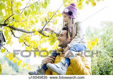 Father and daughter looking at branch View Large Photo Image Stock Photography - Father and daughter looking at branch. Fotosearch