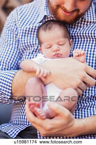 Picture - Father holding daughter (2-5 months). Fotosearch