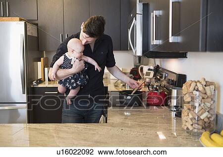 Father kissing baby daughter (2-5 months) while stirring food View Large Photo Image Stock Image - Father kissing baby daughter (2-5 months) while stirring food. Fotosearch