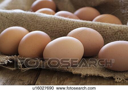 Stock Image - Fresh animal eggs on wood. Fotosearch