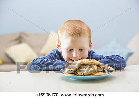 Girl (2-3) looking on plate of cookies View Large Photo Image Stock Image - Girl (2-3) looking on plate of cookies. Fotosearch