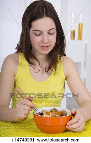 Girl eating bowl of breakfast cereal View Large Photo Image Stock Image - Girl eating bowl of breakfast cereal. Fotosearch