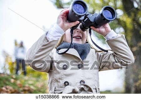 Stock Photograph - Girl looking through binoculars. Fotosearch