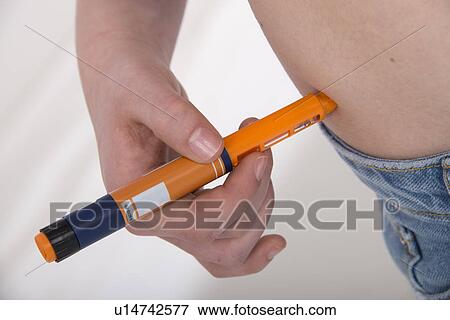 Stock Photo - Girl with diabetes injecting herself. Fotosearch