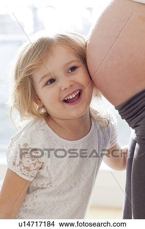Picture - Girl with pregnant mother. Fotosearch