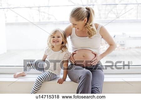 Girl with pregnant mother View Large Photo Image Stock Photo - Girl with pregnant mother. Fotosearch