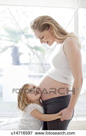 Stock Photo - Girl with pregnant mother. Fotosearch