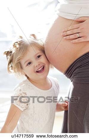 Girl with pregnant mother View Large Photo Image Stock Photo - Girl with pregnant mother. Fotosearch