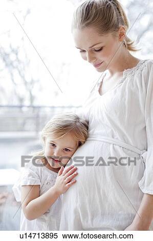 Stock Photography - Girl with pregnant mother. Fotosearch