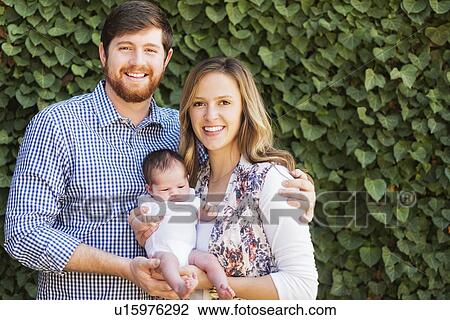 Happy parents holding girl (2-5 months) View Large Photo Image Stock Image - Happy parents holding girl (2-5 months). Fotosearch