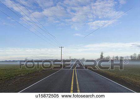 Highway going through plain covered with fog View Large Photo Image Stock Photography - Highway going through plain covered with fog. Fotosearch