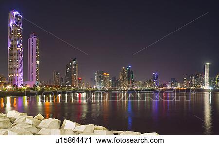 Stock Image - Illuminated cityscape at night. Fotosearch