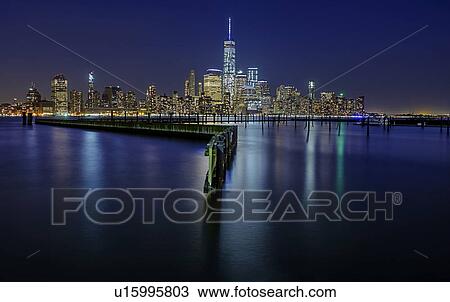 Stock Image - Illuminated cityscape at night. Fotosearch
