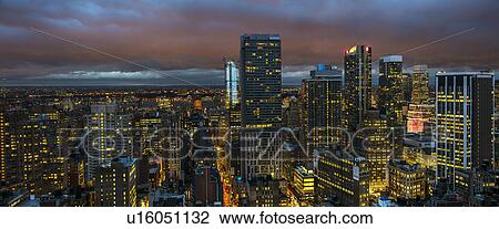 Stock Image - Illuminated cityscape at night. Fotosearch