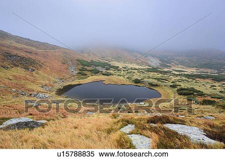 Lake Nesamovyte in fogy landscape View Large Photo Image Stock Photography - Lake Nesamovyte in fogy landscape. Fotosearch