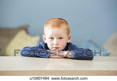 Picture - Little boy (2-3) leaning on table. Fotosearch