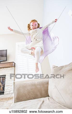 Little girl (4-5) playing superhero on sofa View Large Photo Image Stock Image - Little girl (4-5) playing superhero on sofa. Fotosearch