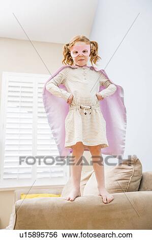 Little girl (4-5) playing superman on sofa View Large Photo Image Stock Photograph - Little girl (4-5) playing superman on sofa. Fotosearch