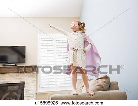 Little girl (4-5) playing superman on sofa View Large Photo Image Stock Photograph - Little girl (4-5) playing superman on sofa. Fotosearch