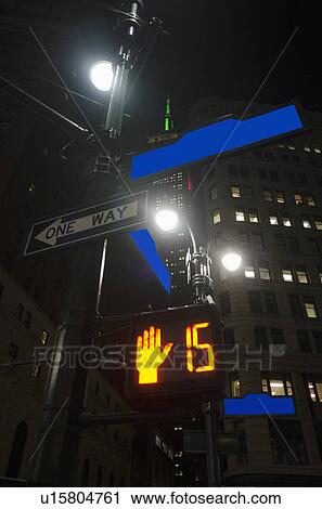 Stock Image - Low-angle view of directional signs in city. Fotosearch