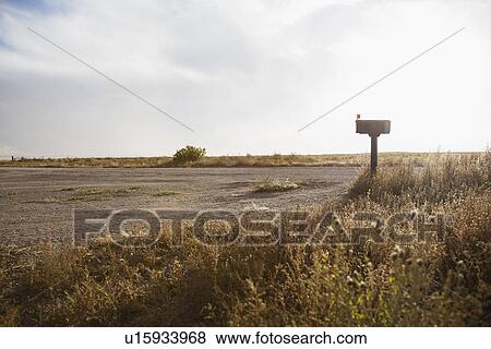 Mailbox by empty dirt road View Large Photo Image Stock Photo - Mailbox by empty dirt road. Fotosearch