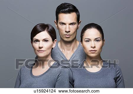 Man and two women wearing grey tops View Large Photo Image Picture - Man and two women wearing grey tops. Fotosearch