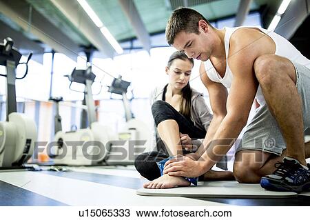 Man applying ice pack on woman's ankle View Large Photo Image Stock Image - Man applying ice pack on woman's ankle. Fotosearch