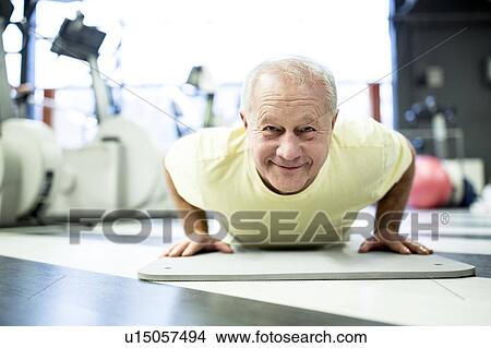Man exercising in gym View Large Photo Image Picture - Man exercising in gym. Fotosearch