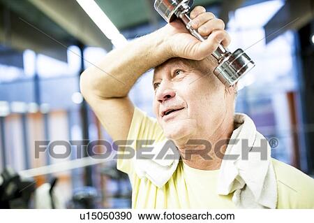 Man holding dumbbell View Large Photo Image Stock Image - Man holding dumbbell. Fotosearch