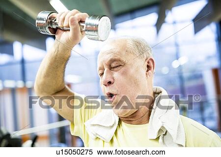 Stock Photography - Man holding dumbbell. Fotosearch