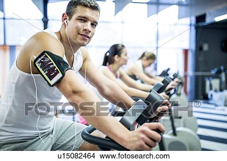 Picture - Man listening to music in gym. Fotosearch