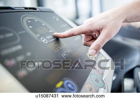 Stock Image - Man pushing button of control panel. Fotosearch