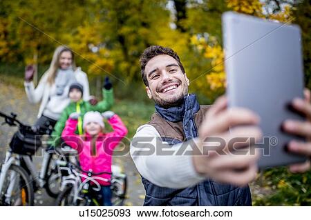 Man taking a photo of family View Large Photo Image Stock Image - Man taking a photo of family. Fotosearch