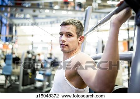 Man using exercise machine View Large Photo Image Stock Image - Man using exercise machine. Fotosearch