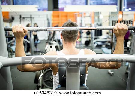 Man using exercise machine View Large Photo Image Stock Photo - Man using exercise machine. Fotosearch
