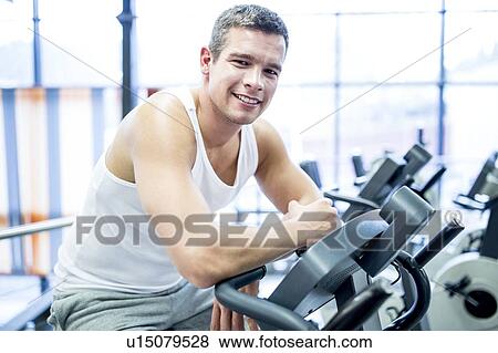 Man working out in gym View Large Photo Image Stock Photo - Man working out in gym. Fotosearch