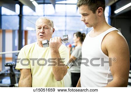Stock Photo - Man working out with dumbbells. Fotosearch