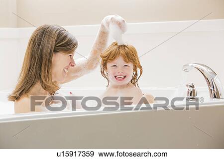 Mother and daughter (4-5) having bubble bath View Large Photo Image Stock Photo - Mother and daughter (4-5) having bubble bath. Fotosearch