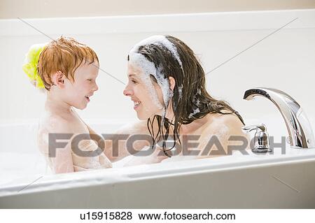 Stock Photo - Mother and son (2-3) having bubble bath. Fotosearch