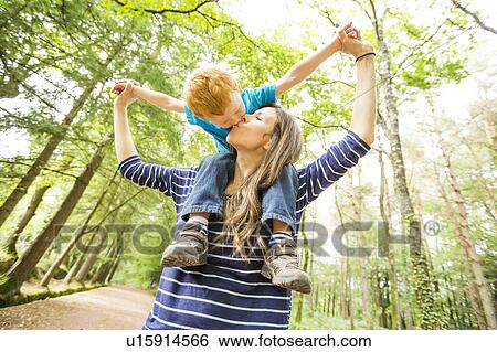 Mother carrying on shoulders son (2-3) View Large Photo Image Stock Photograph - Mother carrying on shoulders son (2-3). Fotosearch
