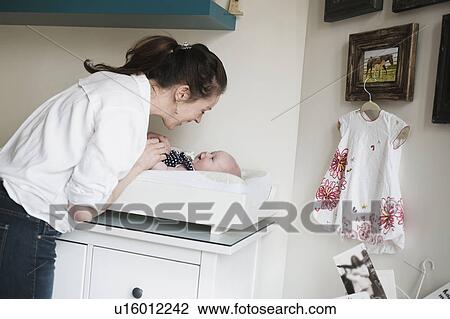 Mother playing with baby daughter (2-5 months) View Large Photo Image Stock Image - Mother playing with baby daughter (2-5 months). Fotosearch