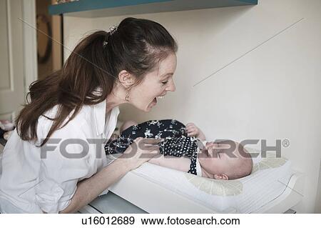 Mother playing with baby daughter (2-5 months) View Large Photo Image Stock Photo - Mother playing with baby daughter (2-5 months). Fotosearch