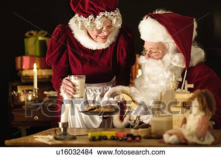 Mrs. Claus bringing homemade cookies to Santa Claus View Large Photo Image Picture - Mrs. Claus bringing homemade cookies to Santa Claus. Fotosearch
