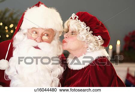 Mrs. Claus kissing Santa on cheek View Large Photo Image Stock Image - Mrs. Claus kissing Santa on cheek. Fotosearch