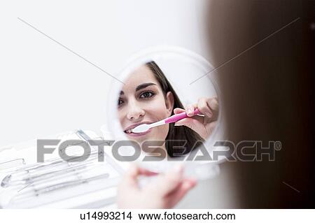 Picture - Patient brushing and doctor looking. Fotosearch