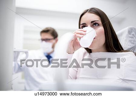 Stock Image - Patient holding disposable cup. Fotosearch