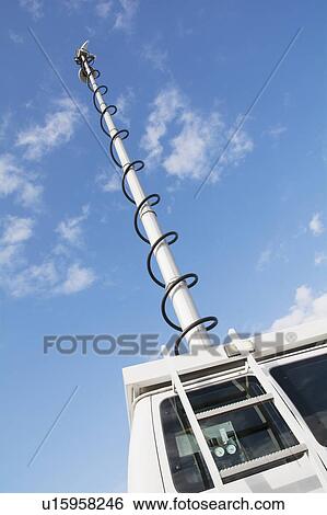 Stock Photograph - Pole of news van against sky. Fotosearch