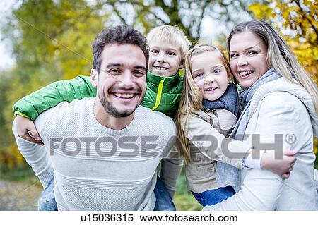 Portrait of family enjoying in autumn View Large Photo Image Stock Photography - Portrait of family enjoying in autumn. Fotosearch