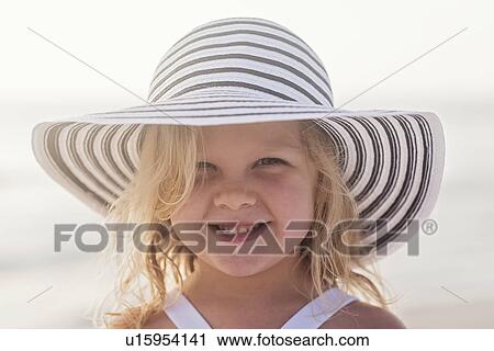 Portrait of girl (4-5) in sunhat at beach View Large Photo Image Stock Image - Portrait of girl (4-5) in sunhat at beach. Fotosearch